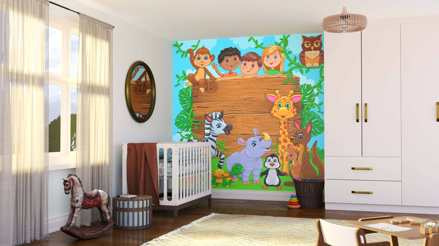 A bright nursery features the Wildlife Welcome Wall Mural with illustrated children, a giraffe, zebra, monkey, rhino, and penguin. The room includes a crib, rocking horse, mirror, baskets, and wardrobe with sunlight streaming in.