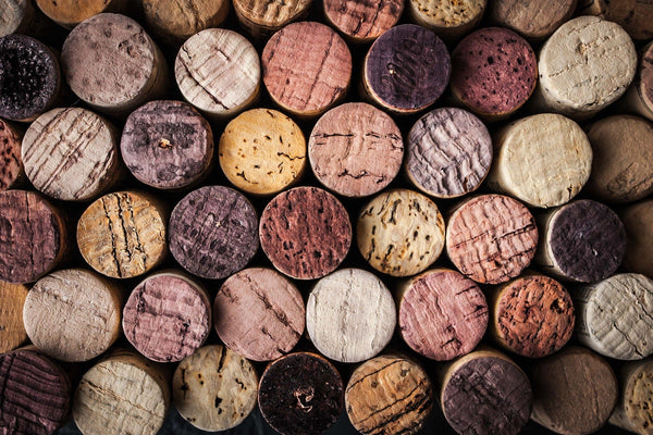 A close-up of the Wine Corks Wall Mural by displays horizontally arranged corks in natural colors from light beige to dark brown and reddish hues, showcasing textures and grain patterns reminiscent of removable wallpaper designs.