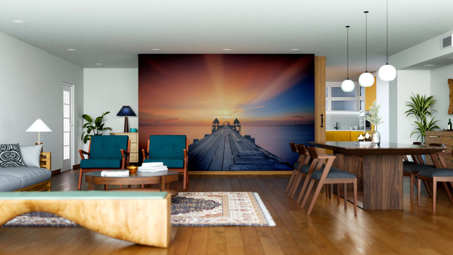 A modern open-concept space features wooden floors, teal chairs, and a Wooded Bridge Landscape Wall Mural. Warm sunlight, stylish lighting, plants, and contemporary accents complete this inviting living and dining area.