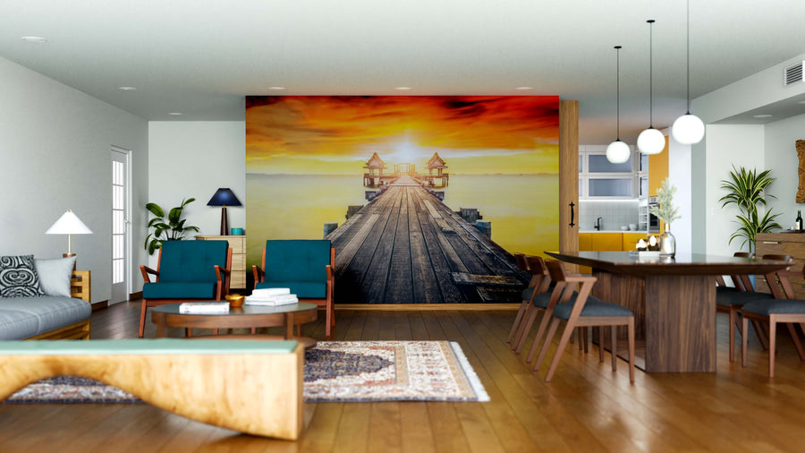 A bright, modern living-dining space with wood furniture and teal chairs features the Wooden Bridge Wall Mural, depicting a pier at sunset with warm orange tones for a dramatic focal point.