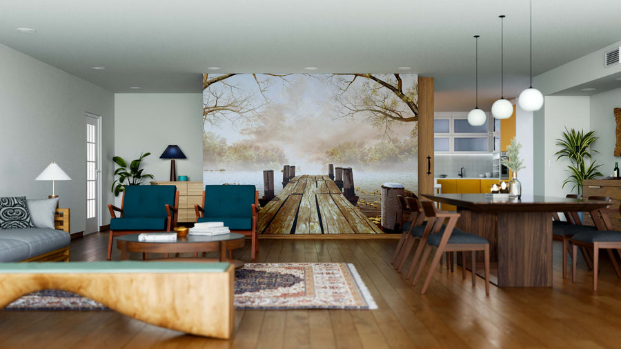 A modern living-dining room with wooden floors, teal and wood furniture, and decorative rugs features the Wooden Dock Wall Mural—a custom print of a dock stretching into a misty lake—adding depth and style to the open-plan space.