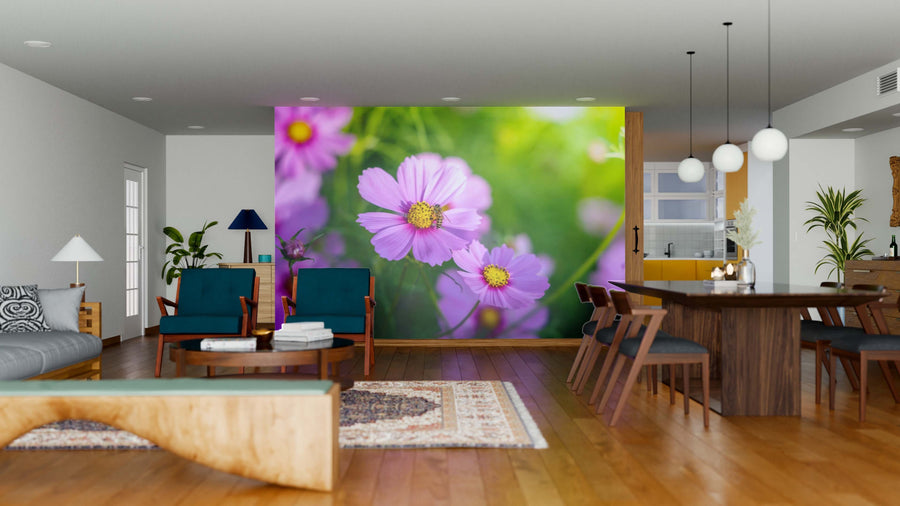 A modern open-plan living and dining area features wood floors, stylish furniture, and the Beautiful Cosmos Flowers Wall Mural, displaying close-up pink cosmos and green foliage for a vibrant, nature-inspired touch.