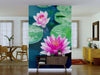 A living room features the Beautiful Pink Lotus Wall Mural with pink water lilies and green lily pads. In front sits a console table, dining set, yellow dresser, mirror, and two large windows with sheer curtains.