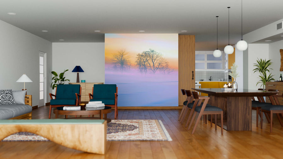A modern open-plan living and dining area features wooden floors, mid-century furniture, the Beautiful Twilight Wall Mural with a misty winter scene, dark blue chairs, a patterned rug, indoor plants, and a dining table with pendant lights.