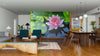 A modern open living and dining space with wood floors, blue chairs, and the Blooming Lotus Wall Mural featuring a pink water lily and green lily pads creates a vibrant focal point. Pendant lights and mid-century furniture complete the look.
