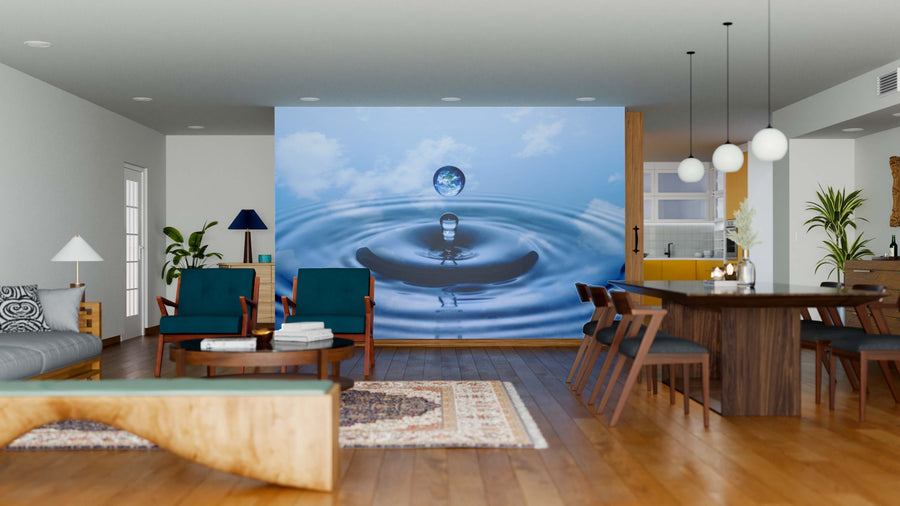 A modern open-concept living and dining area features wood floors, blue armchairs, a wooden dining table, and the Drop of Rain Wall Mural; hanging lights and plants add warmth to this inviting space.