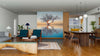 Modern open-concept living and dining area with wood floors and mid-century furniture. A striking Flooded Landscape Wall Mural divides the living room from the yellow-accented kitchen in the background.