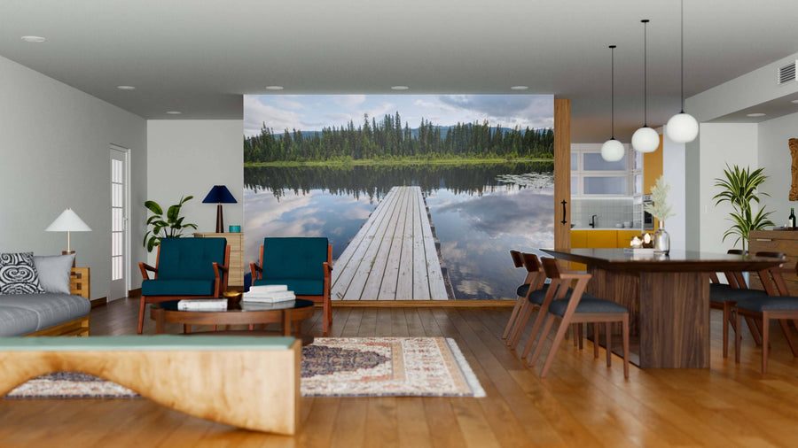 A modern open living and dining space with wooden floors, stylish furniture, and a large Mountain Lake in Canada Wall Mural depicting a dock leading onto a calm lake, bringing depth and natural beauty into the room.