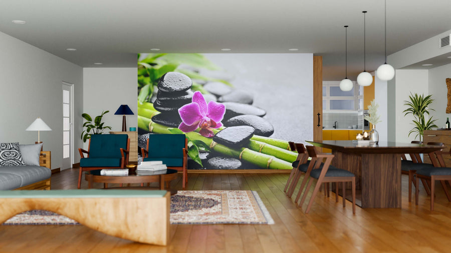 Modern living-dining area with wood floors, mid-century furniture, and an Orchid on Bamboo Wall Mural featuring black stones and a pink orchid. Blue chairs, wooden table, rugs, pendant lights, and an open kitchen complete the space.