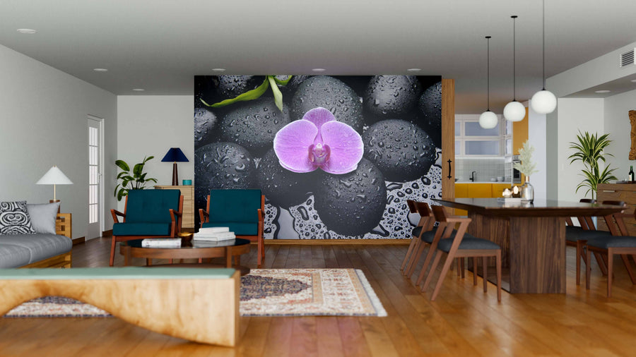 Modern living-dining room with wooden floors, teal and wood furniture, and a large peel and stick Pink Orchid Wall Mural with wet black stones. The space is bright, featuring plants, pendant lights, and an open layout connecting both areas.
