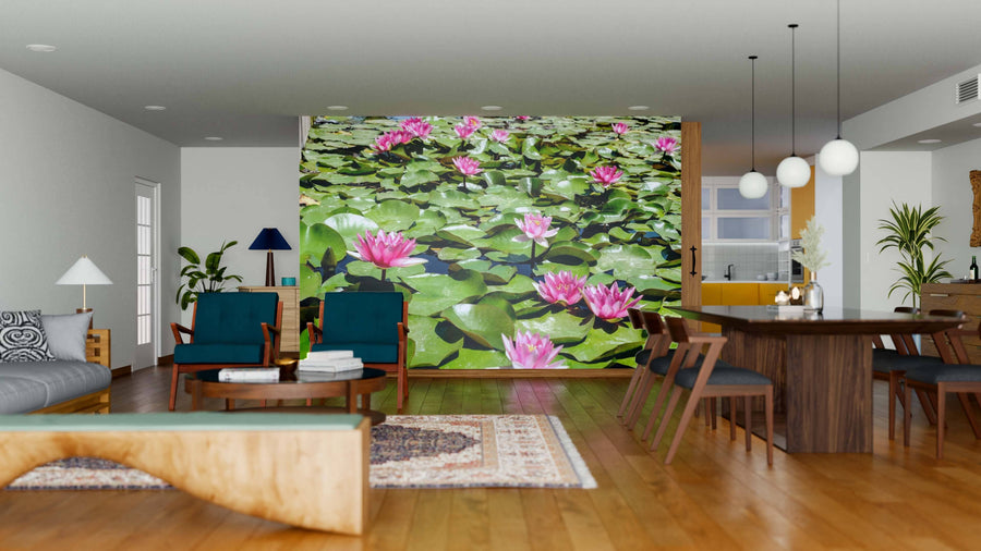 A modern open-plan living and dining room with wooden floors and mid-century furniture features the Pink Waterlily Wall Mural, creating a vibrant focal point with pink water lilies and green lily pads for a nature-inspired look.