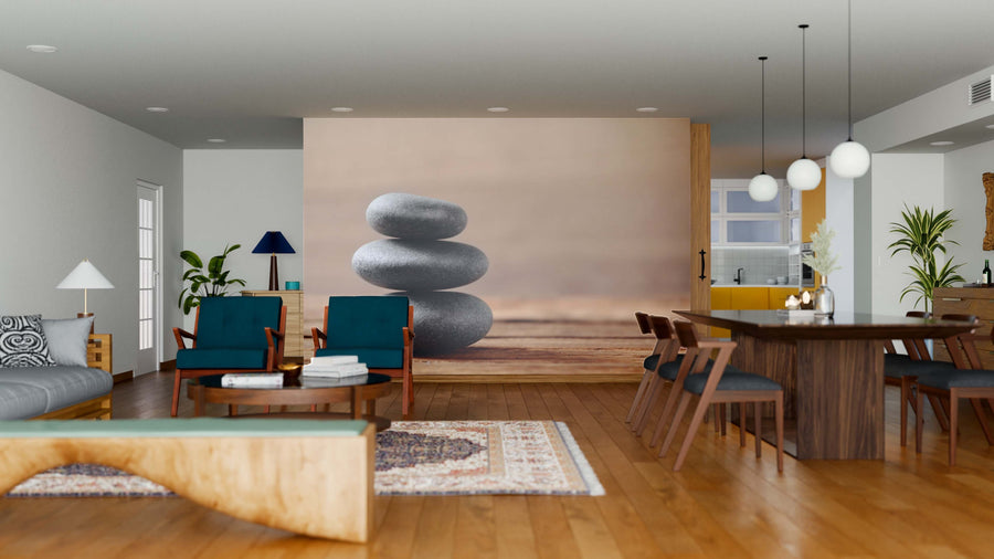 A modern open-plan living and dining room with wooden floors, teal armchairs, a wooden table, pendant lights, and a Spa Stones Wall Mural that adds tranquility to the minimalist decor.