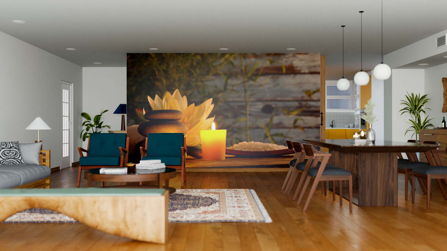 A spacious modern living-dining area with wooden floors and blue armchairs features the Still Life Wall Mural—an easy-to-update, peel and stick wallpaper depicting a yellow candle, stones, and flowers for a calming, spa-like ambiance.