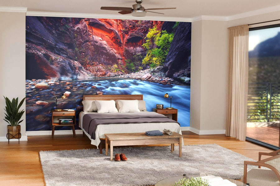 A modern living-dining room features wood floors, contemporary furniture, and a striking Zion Canyon Narrows Wall Mural with a flowing river and red canyon, adding vibrant natural scenery to the sophisticated interior.