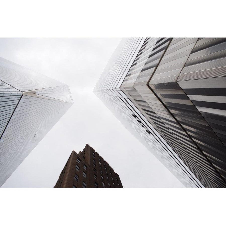 The Big Future Wall Mural by CEILING transforms your space with urban vistas, featuring three modern skyscrapers with reflective glass and striped facades, while a central tower stands out with its classic brown exterior and vertical lines against the cloudy sky.