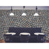 A CITYSCAPES & SKYLINES black Cobble Stone table and chairs in a restaurant with a brick wall adorned with a peel and stick wall mural.
